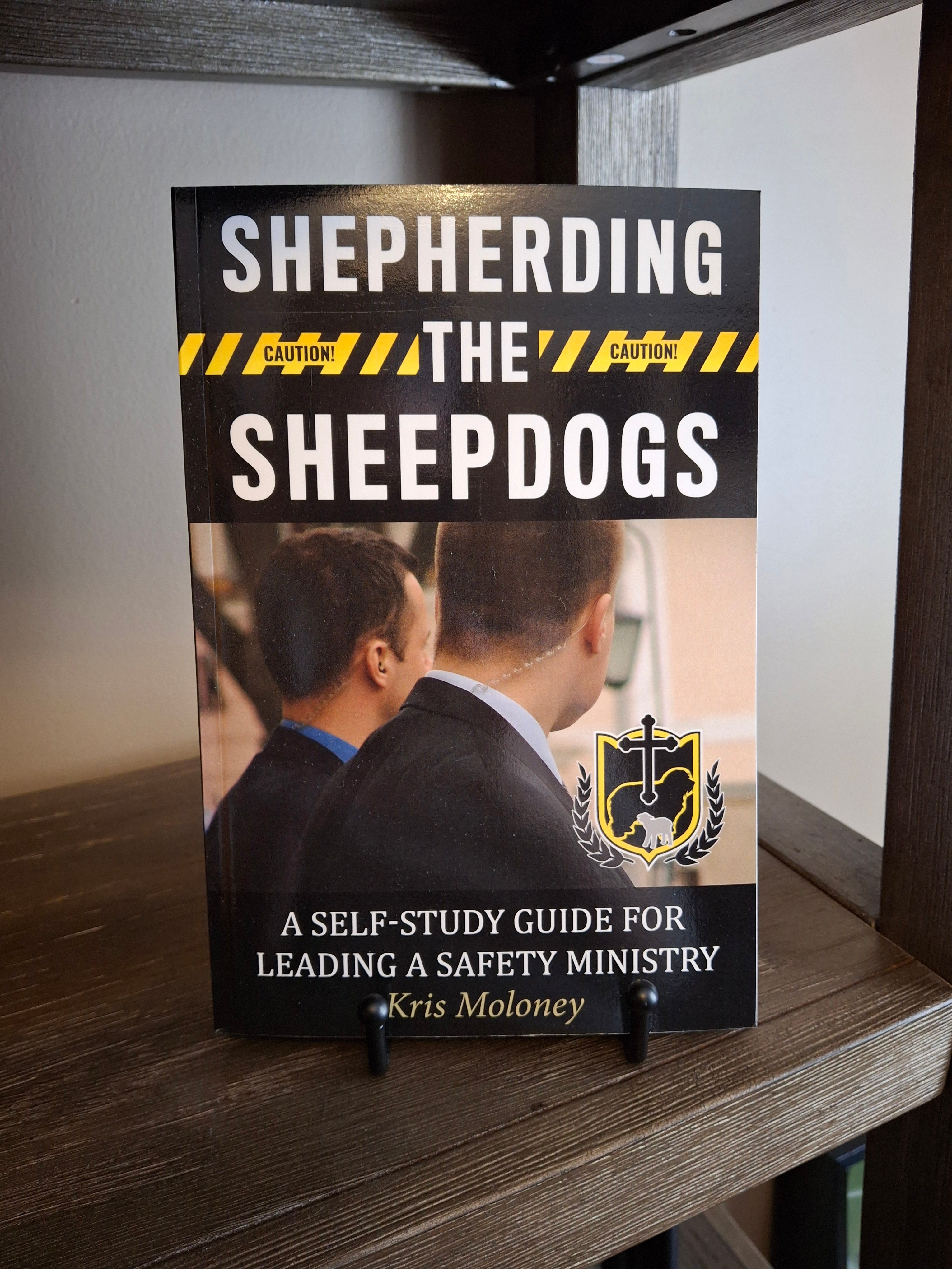 Shepherding the Sheepdogs paperback self-study guide for leading a church safety ministry displayed on a shelf